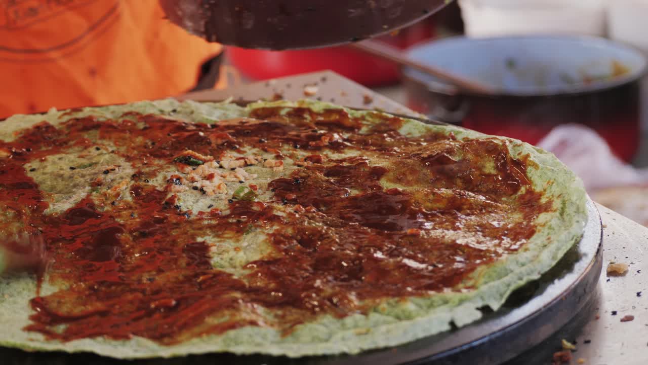 Chinese traditional street food Jianbing close-up. Cooking asian crepe Jianbing, one of China most popular street breakfasts. High quality 4k footage