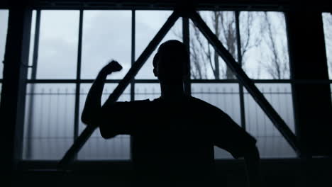 dancer silhouette having fun in dark class. unknown guy dancing hip hop studio