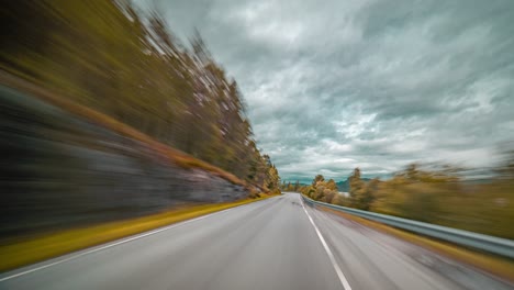 a fast drive on the narrow two-lane rural road along the tingvollfjorden fjord near sunndalsora, norway