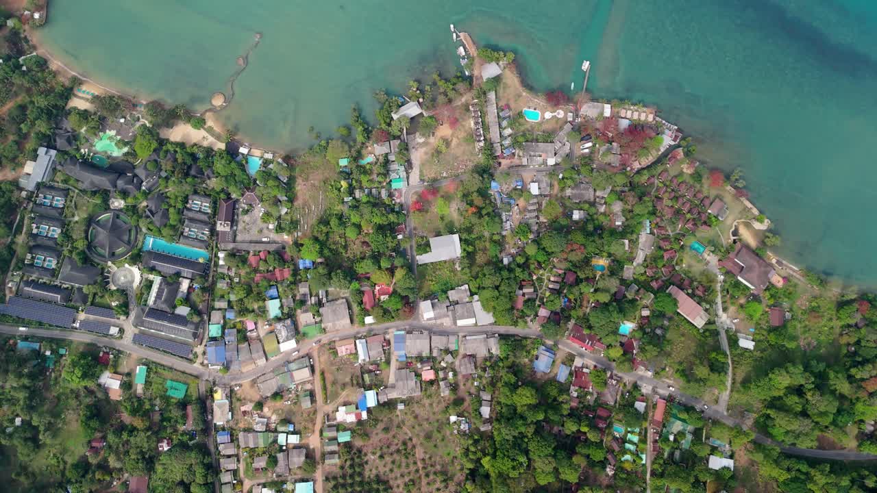 Aerial drone footage capturing the tranquil Bailan Village, beach, and tropical resorts on Koh Chang, Thailand