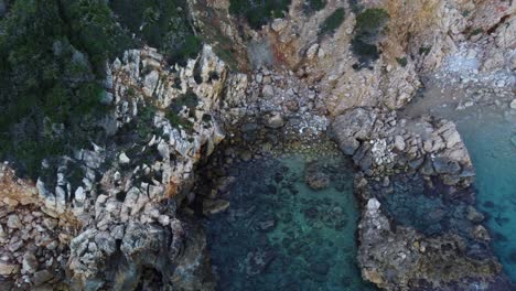 stunning aerial of paradisiac secluded bay with turquoise water, sardinia