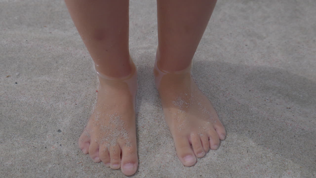 Small girls feet in shallow sea