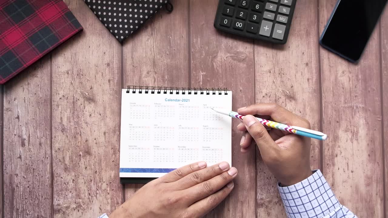 Person Planning Schedule Using a 2021 Calendar