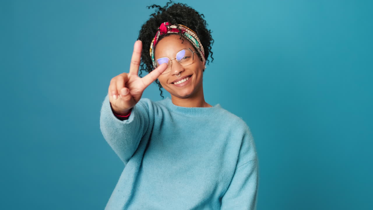 Young African American Woman Smiling and Showing Peace Sign