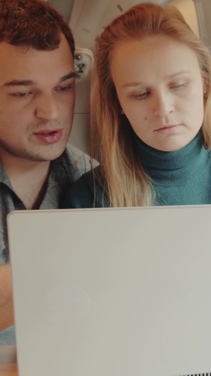 Couple Using Laptop on Train