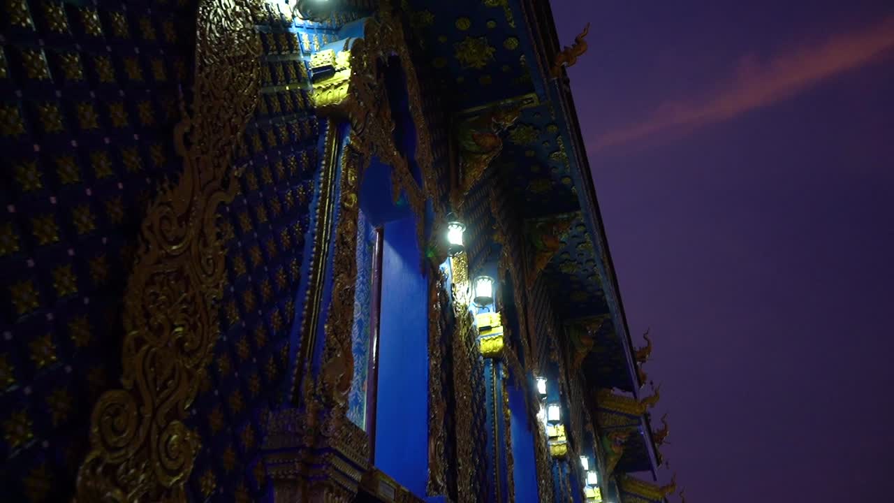 Sideway movement by the main building at sunset at Wat Rong Sear Tean (Blue Temple). Chiang Rai, Thailand.