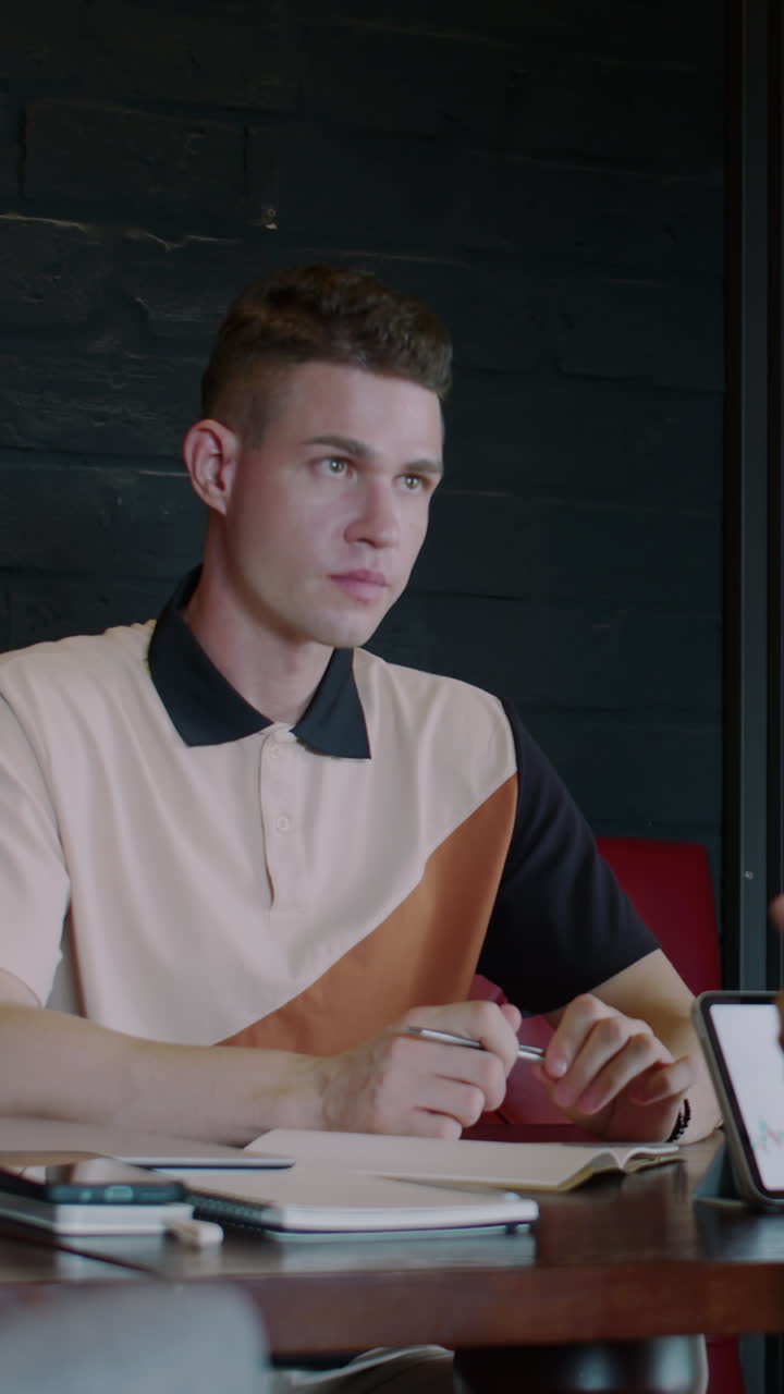 Financial Analyst Consulting Client in Coworking Space