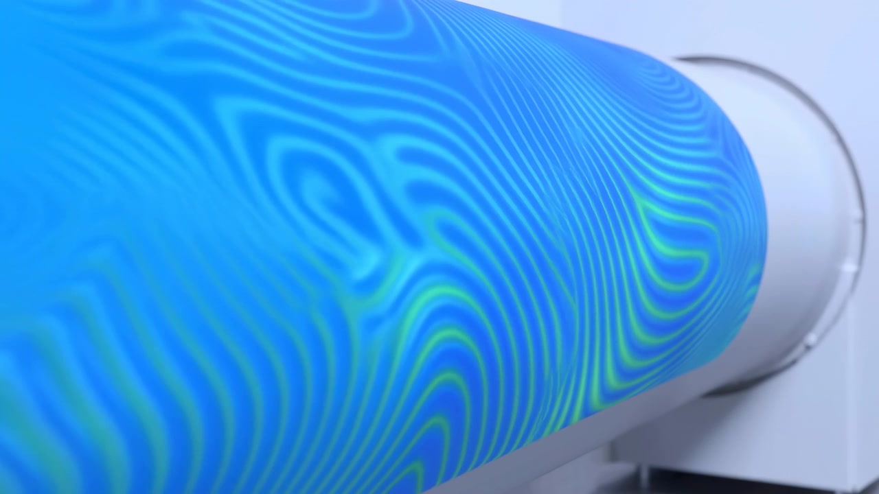 A cylindrical object featuring a blue and green abstract pattern remains static throughout the video frames, creating a neutral mood. The setting is unknown, and the camera maintains.