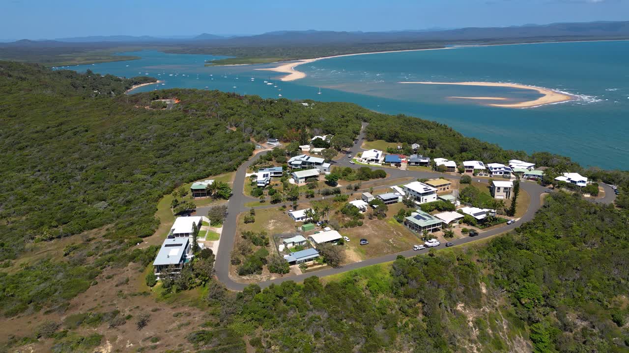 Aerial View of Coastal Houses on a Hillside Overlooking a Bay