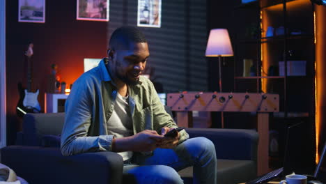 vertical video smiling young adult chatting with friends over texts on mobile phone