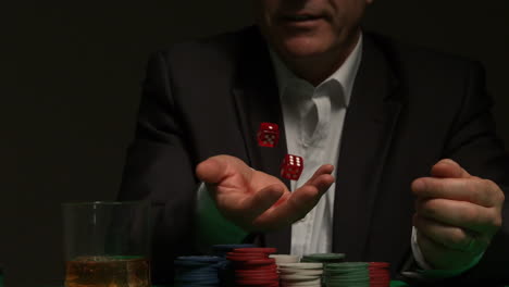 cool gambler throwing red dice