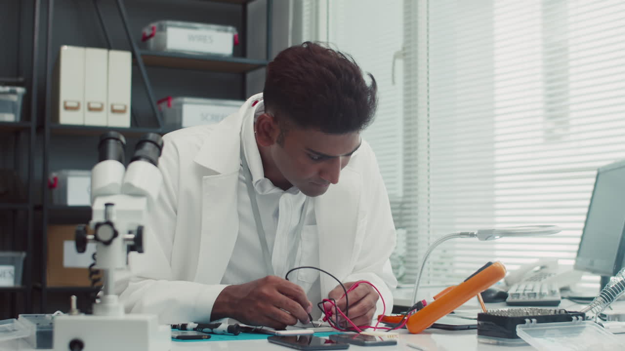 Technician Using Multimeter when Examining Clients Smartphone