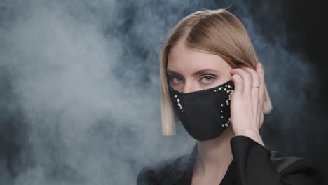 portrait of elegant woman in beaded face mask