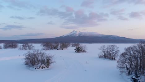 Forward-aerial-flight-slowly-rising-over-beautiful-snowed-in-landscape