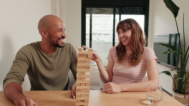 Couple Plays Jenga and Laughs at Home