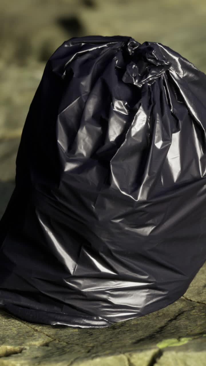 Single black trash bag emphasizes cleanliness and city waste management