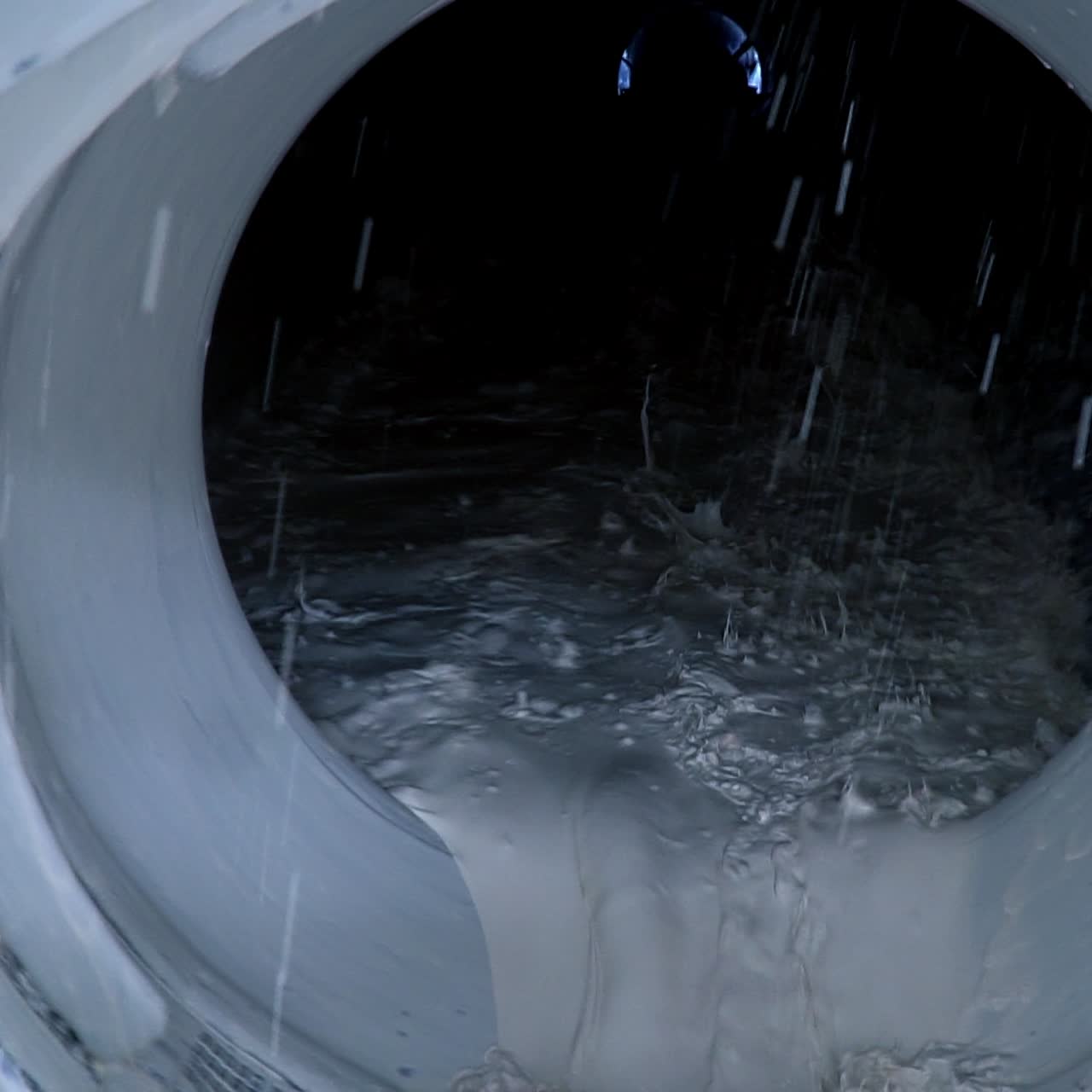 Filtering white kaolin in the rotating mechanism at the factory. Modern plant for processing industrial minerals. Close up