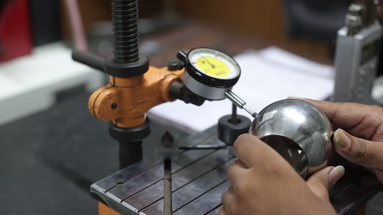 man checking a ball part in inside the lab