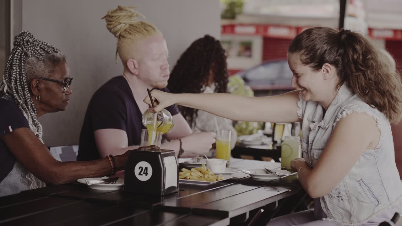 Friends Enjoying Drinks and Snacks at an Outdoor Cafe