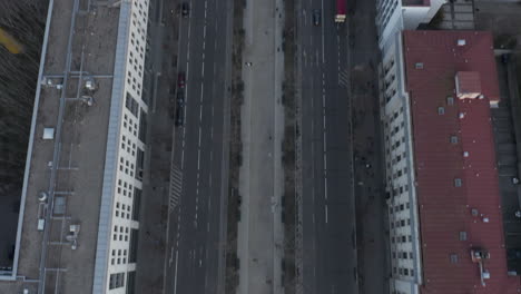 AERIAL:-Slowly-tilting-up-over-Berlin-Central-with-Pedestrians-on-Sidewalk-and-Car-Traffic
