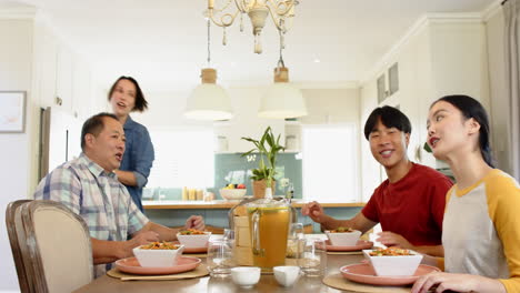 eating together, family enjoying meal and conversation in kitchen dining area