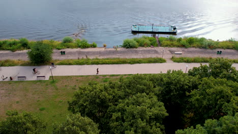 people immerse in healthy activities such as cycling,jogging near river banks