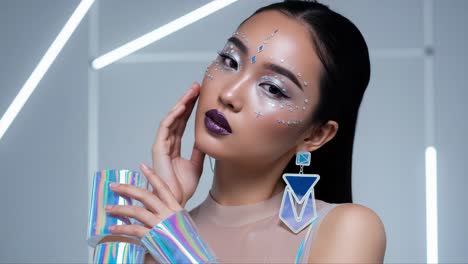 captivating fashion portrait of a model with artistic makeup and futuristic accessories highlighting elegance and creativity in a modern setting
