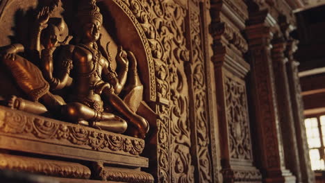 intricate wooden carving of a hindu deity