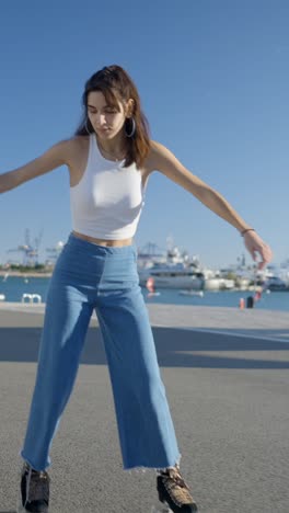 young woman roller skating at the harbor