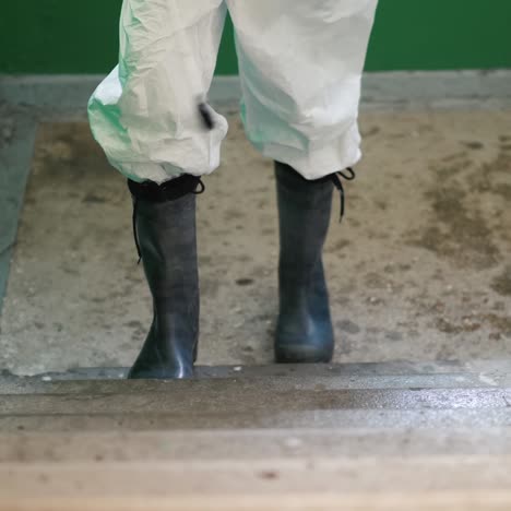 Worker-In-Protective-Clothing-Sprays-The-Stairs-Of-An-Apartment-Building-With-Antiseptic