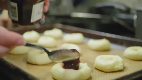 filling cookies with raspberry jam