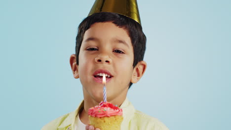 blowing candle, child and a cupcake