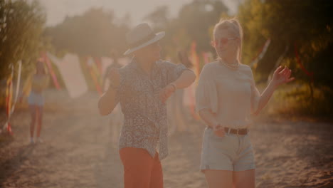 young man and woman grooving to music at beach