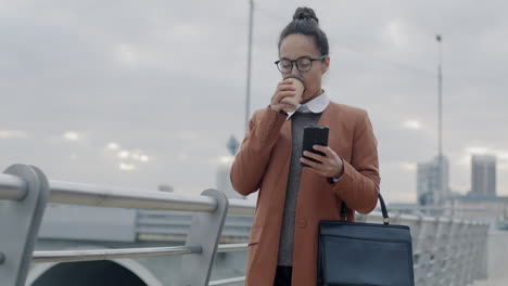 businesswoman walking and using smartphone