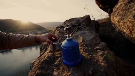 someone put blue gas and coffee pot on rock to prepare coffee, vogelberg, lepontine alps