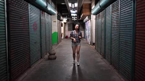 woman with headset walking in underground corridor