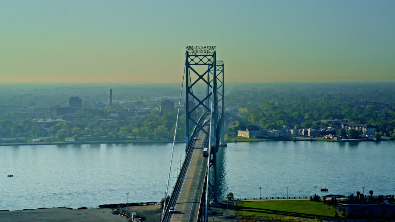 Smooth cinematic aerial view of the Ambassador Bridge joining the United States and Canada