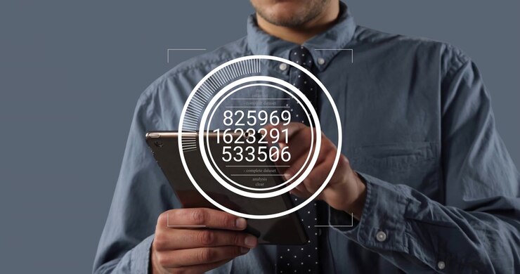 Man holding tablet, tapping screen, showing HUD, updating numbers for business on gray backdrop