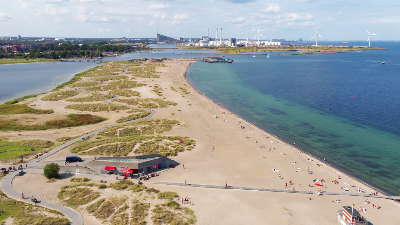 Aerial drone view of Amager Strandpark beach and dunes, with the Copenhagen skyline visible in the distance