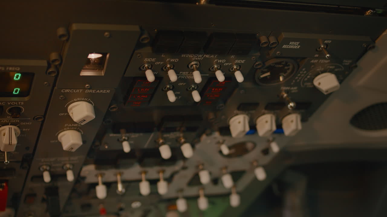 Airplane captain starting aircraft engine power buttons