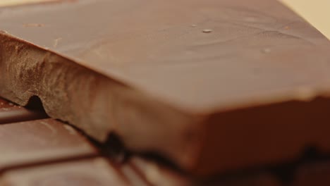 beautiful macro dolly of delicious chocolate tablet on a wooden surface