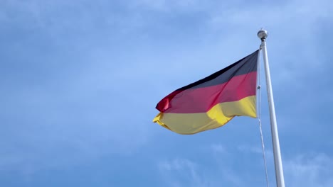 german flag waving against a clear sky