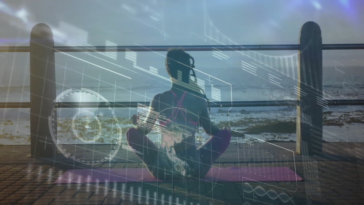 Silhouette of person meditating by ocean with digital data overlay animation