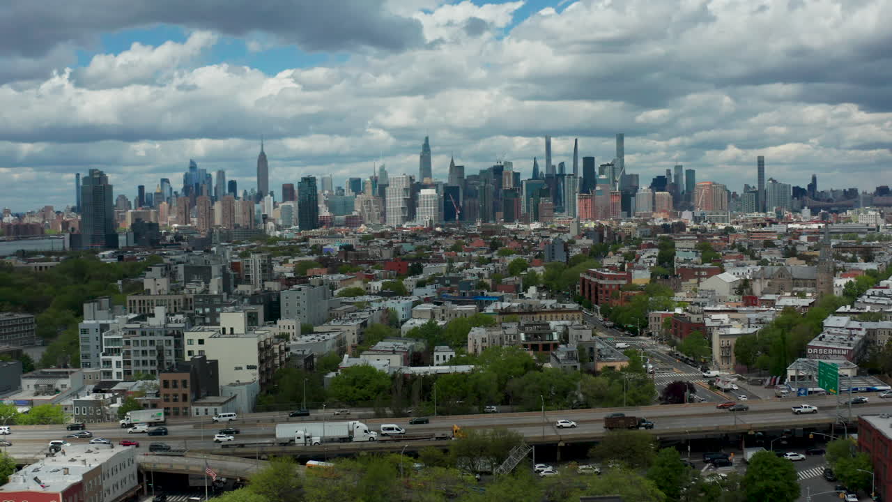 Captivating drone push shot revealing Brooklyn's urban charm and the iconic New York City skyline, with a focus on the BQE in the foreground