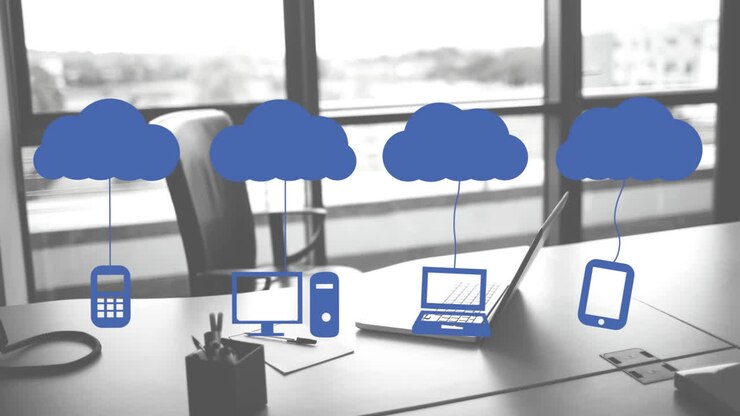 Animation of clouds and digital icons over laptop on desk
