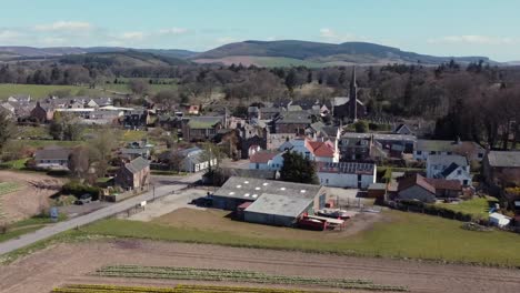 Aerial-view-of-the-Scottish-town-of-Fettercairn-on-a-sunny-spring-day,-Aberdeenshire,-Scotland