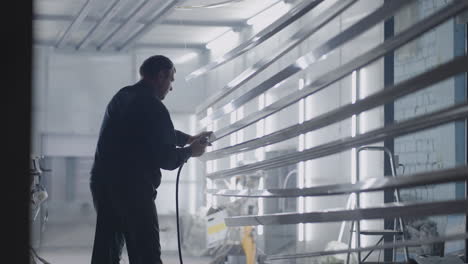 men in the production of steel structures prepare parts for painting in the paint shop