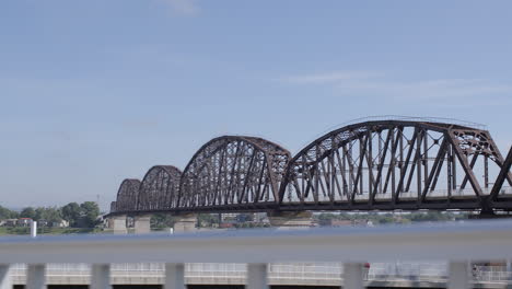 view of the big four bridge and the ohio river from louisville, kentucky on a summer day