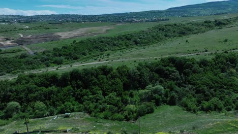 drone shoot for green mountains with a lot of nice trees at the start of the summer afternoon time with clear sky