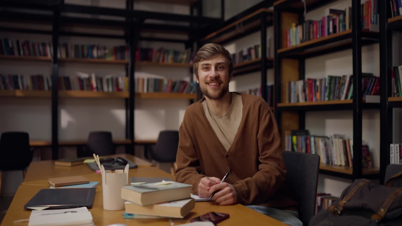 Young Man Studying in a Library